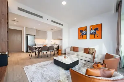 a living room with a couch and a table at Luxury 2-Bed Retreat with Stunning Creek Views in Dubai