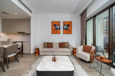 a living room with a couch and a table at Luxury 2-Bed Retreat with Stunning Creek Views in Dubai