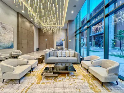 a living room with a couch and chairs and a chandelier at Luxury Studio in Peninsula Five, Business Bay in Dubai