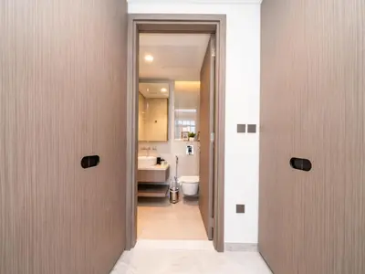a hallway with two doors leading to a bathroom at Brand New Business Bay 1 Bed with Burj Khalifa and Canal Views in Dubai