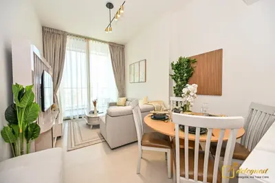 a dining room and living room with a table and chairs at Marvelous 1BR in Binghati Amber by deleguest in Dubai