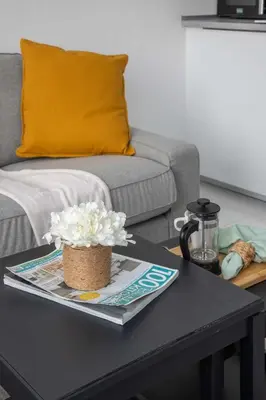 a black coffee table with a flower on top of it at Frank Porter - Serenity Lakes 5 in Dubai