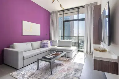 a living room with a couch and a purple wall at Frank Porter - MBL Royal in Dubai