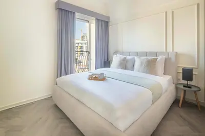 a bedroom with a large white bed with a window at Frank Porter - Rokane G22 in Dubai