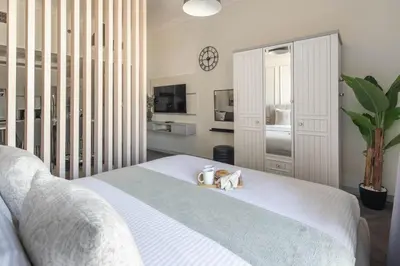 a bedroom with a white bed with two candles on it at Frank Porter - Rokane G22 in Dubai