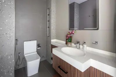 a bathroom with a white sink and a mirror at Frank Porter - MBL Royal in Dubai