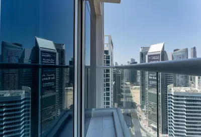 a view of a city skyline from an office window at HAVN - 1 Bed in Damac Hills 1, Golf Course View in Dubai