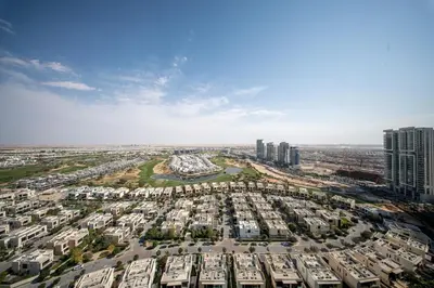 an aerial view of a large city with tall buildings at HAVN - 1 Bed in Damac Hills 1, Golf Course View in Dubai