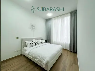 a bedroom with a bed and a sign on the wall at Stylish 1BR Apartment in JVC in Dubai