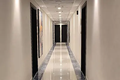 a corridor of a building with white walls and a long hallway at Gemz by Danube - Al Furjan by Golden Casa in Dubai
