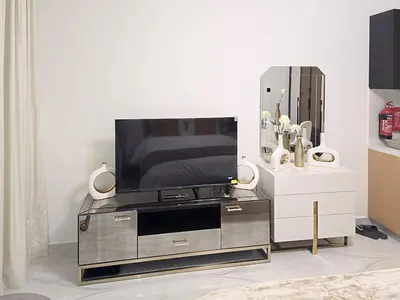 a flat screen tv sitting on top of a entertainment center at Gemz by Danube - Al Furjan by Golden Casa in Dubai