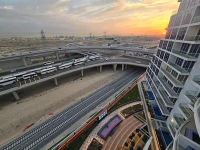 a highway with cars on it and a bridge with traffic at Gemz by Danube - Al Furjan by Golden Casa in Dubai