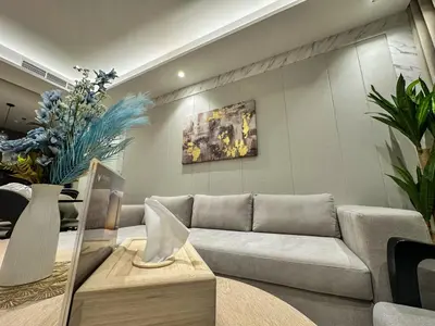 a living room with a couch and some plants at Vserve High Floor Bliss in Dubai's Iconic Skyline in Dubai