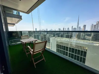 a balcony with a table and chairs and a view of the city at Vserve High Floor Bliss in Dubai's Iconic Skyline in Dubai