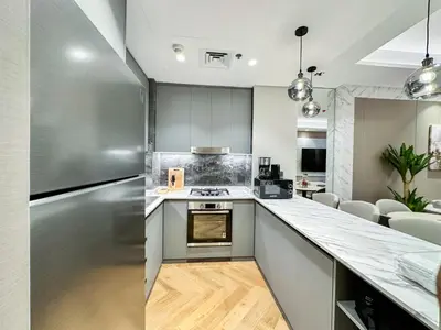 a kitchen with stainless steel appliances and a counter top at Vserve High Floor Bliss in Dubai's Iconic Skyline in Dubai