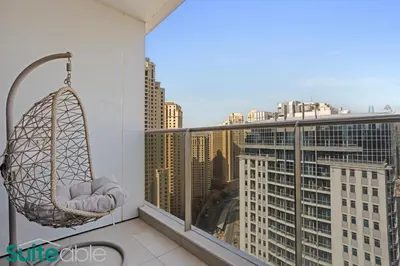 a hammock on a balcony with a view of a city at Chic 1Bedroom with Stunning Marina View in Sparkle in Dubai