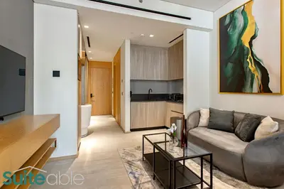 a living room with a couch and a table at Sophisticated Studio in The Autograph in Dubai