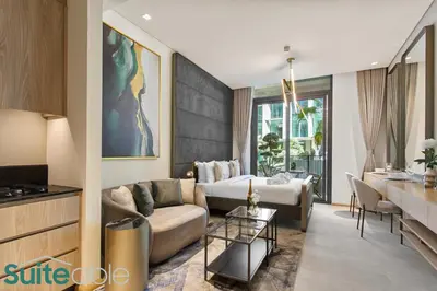 a living room with a couch and a table at Sophisticated Studio in The Autograph in Dubai