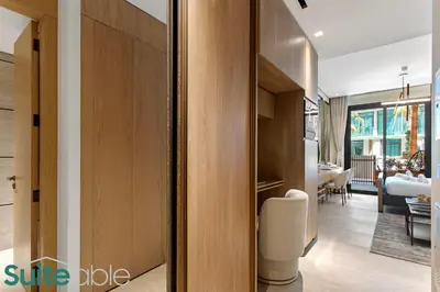 a room with a sliding door and a living room at Chic Studio with Pool Access in The Autograph in Dubai