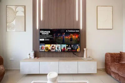 a living room with a flat screen tv on a table at KYMA 2BDR JBR - Luxury Apartment with Full Panoramic Dubai Marina view in Dubai