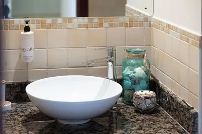 a bathroom with a white bowl sink and a mirror at KYMA 2BDR JBR - Luxury Apartment with Full Panoramic Dubai Marina view in Dubai