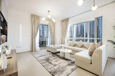 a living room with white furniture and large windows at Best location in Downtown Dubai in Dubai