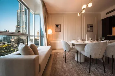 a living room with a table and a large window at Best location in Downtown Dubai in Dubai