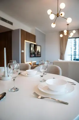 a dining room table with plates and glasses on it at Best location in Downtown Dubai in Dubai