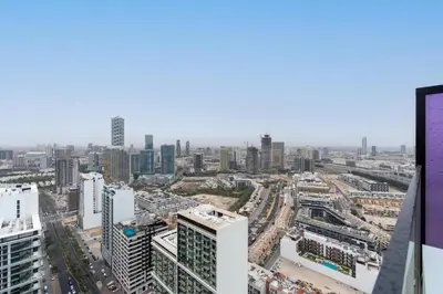an aerial view of a city with tall buildings at Cozy Studio with Sleek Design in JVC in Dubai