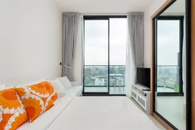 a living room with a white couch and a tv at Cozy Studio with Sleek Design in JVC in Dubai