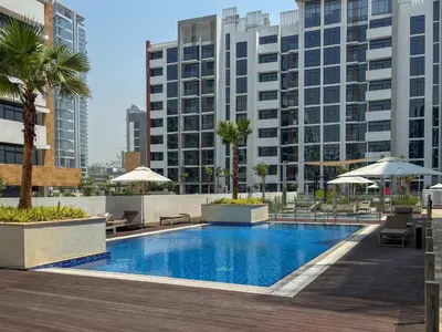 a swimming pool in a building with tall buildings at Frank Porter - Azizi Riviera 28 in Dubai