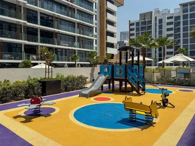 a playground with a slide and a slideintend at Frank Porter - Azizi Riviera 28 in Dubai
