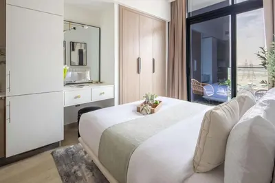 a bedroom with a large white bed and a window at Frank Porter - Azizi Riviera 1 in Dubai