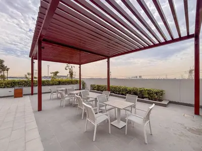 a pavilion with tables and chairs on a patio at Frank Porter - Azizi Riviera 1 in Dubai