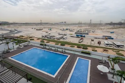 an overhead view of a large parking lot with a pool at Frank Porter - Azizi Riviera 1 in Dubai