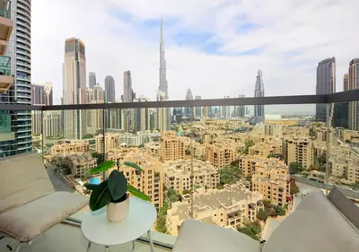 a room with a view of a city skyline at Stylish 2BR in Bellevue Pool, Gym & Burj Views in Dubai