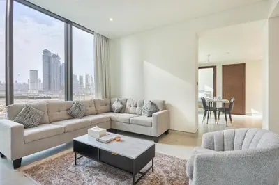 a living room with a couch and a table at STAY BY LATINEM Luxury 1BR Holiday Home CVG 710 Near Burj Khalifa in Dubai