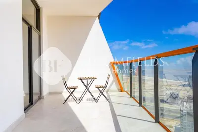 a balcony with chairs and a view of the city at Bloomfields 1Br The Avenue Suite Bingahtti in Dubai
