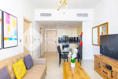 a living room with a couch and a table at Bloomfields 1Br The Avenue Suite Bingahtti in Dubai