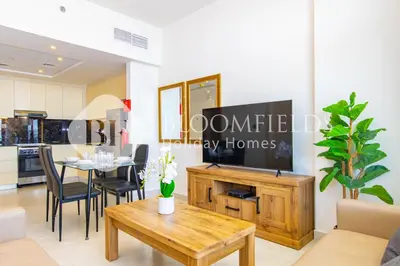 a living room with a table and a kitchen at Bloomfields 1Br The Avenue Suite Bingahtti in Dubai