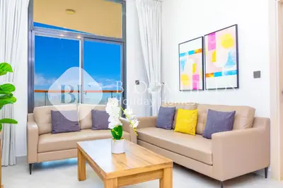 a living room with two couches and a coffee table at Bloomfields 1Br The Avenue Suite Bingahtti in Dubai
