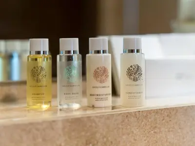 a group of four bottles of moisturizers on a counter at Wonderful Stay At Zaya Hameni - Best Amenities - Unique in JVC - Brand New Luxury Apartments in Dubai