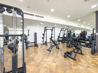 a gym with treadmills and machines in a room at Wonderful Stay At Zaya Hameni - Best Amenities - Unique in JVC - Brand New Luxury Apartments in Dubai