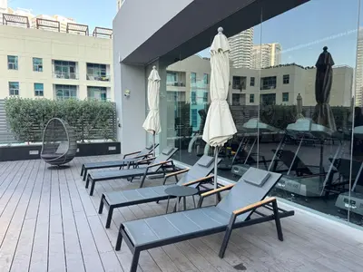 a group of lounge chairs and umbrellas on a building at STUDIO ONE Stunning Marina View - TIE in Dubai