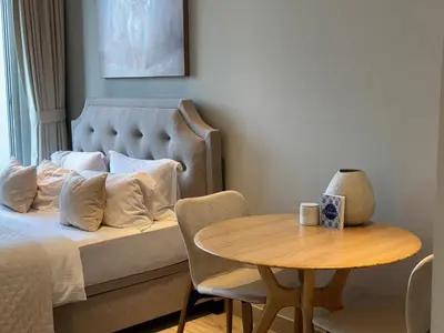 a bedroom with a bed and a table with a coffee cup at STUDIO ONE Stunning Marina View - TIE in Dubai