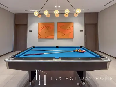 a ping pong table in a room with a pool table at LUX The Grande Signature Skyline Suite 2 in Dubai