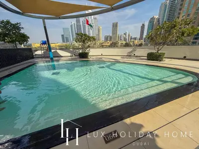 a swimming pool with a view of the city at LUX The Grande Signature Skyline Suite 2 in Dubai