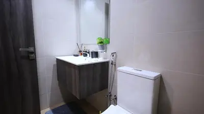 a bathroom with a toilet and a sink at 2 Bedroom Elegant Apartment in Dubailand in Dubai