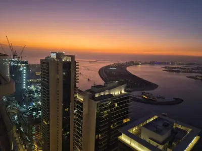 an aerial view of a city at sunset at Luxury Penthouse Retreat - Private Beach, Breathtaking Palm and Marina Views in Dubai