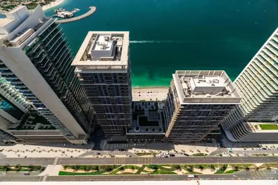 an aerial view of two tall buildings next to the water at Luxury Penthouse Retreat - Private Beach, Breathtaking Palm and Marina Views in Dubai